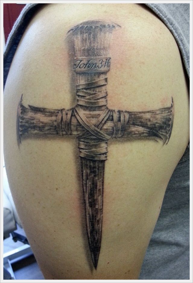 Wooden Tattoo Cross on Man's Shoulder